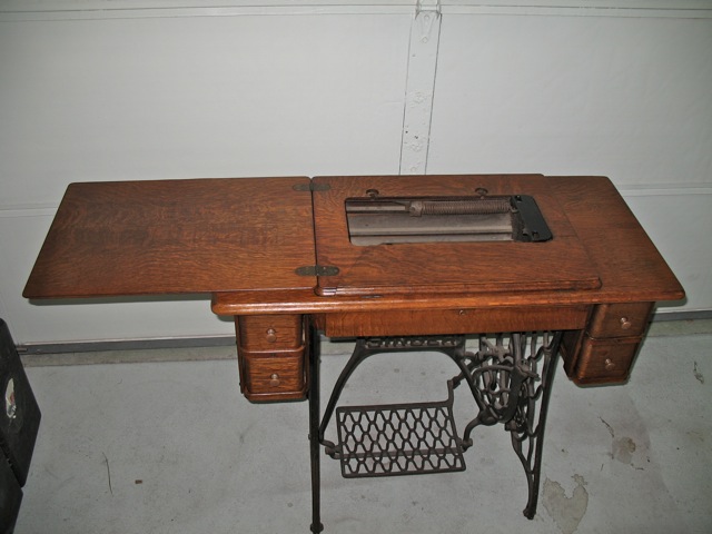 antique sewing machine cabinet open, refinished